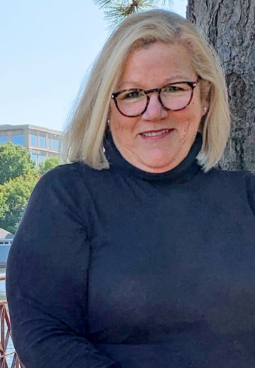 Bruceanne Phillips, a dynamic professional, enhancing client visibility and engaging in humanitarian advocacy through storytelling.